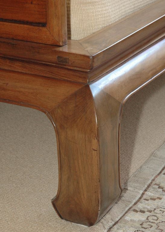 The molded rectangular frame  supported on four massive incurvate legs; the seven panels above in three removable sections; of warm, faded coloration.