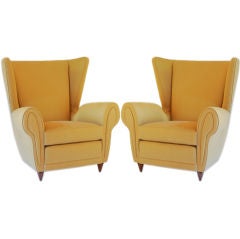A SUMPTUOUS PAIR OF ITALIAN WING-BACK UPHOLSTERED ARMCHAIRS