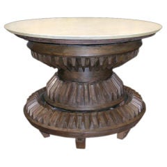 A MASSIVE AMERICAN STAINED PINE COG TABLE WITH LIMESTONE TOP