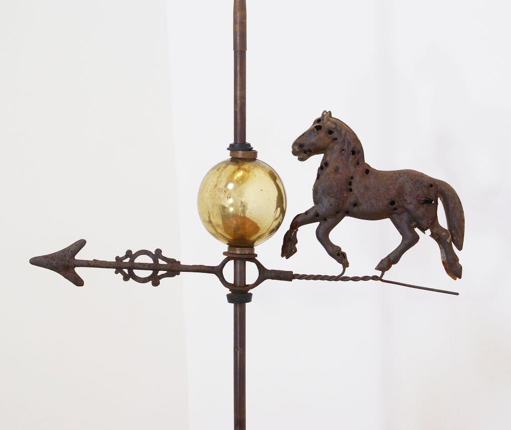 A nice lightning rod weathervane mounted on a plywood base.  The horse has been shot up as usual.  The finish is lightly rusted.