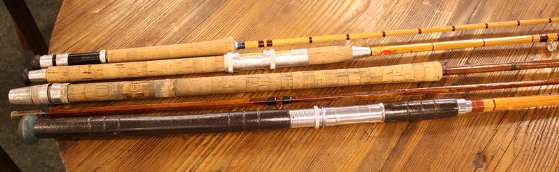 A collection of vintage split cane fishing rods and a tackle basket from 1950's England. The rods range in length from 6 to 12 feet, and are assembled from several sections. Images 3 and 4 show 2 parts of one rod, looks like 5 rods but there are 4.