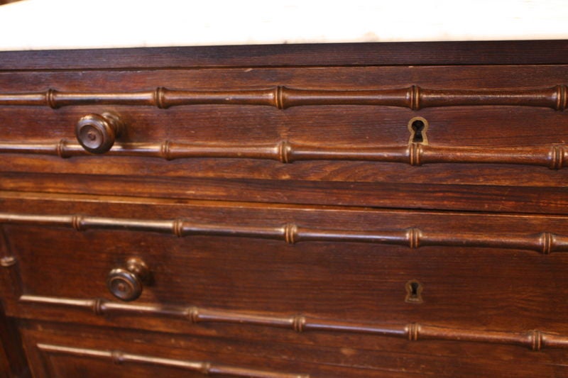An antique faux bamboo bureau from France with the original marble top. Very charming. Four drawers with the original wooden knobs and escutcheons.<br />
<br />
See similar examples of chests on our website BriggsHouse.com.<br />
<br />
Briggs