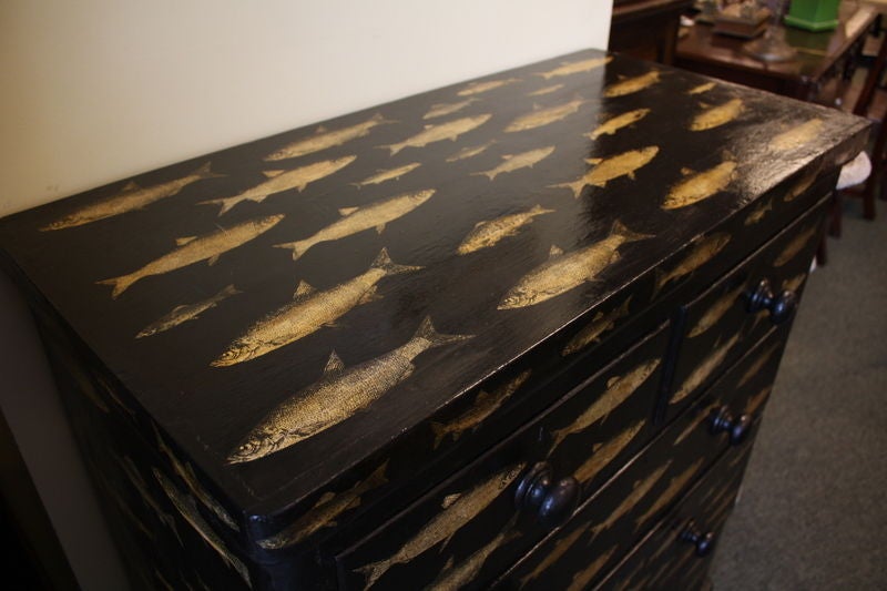An antique two over three pine chest of drawers from England. This Victorian bureau has been newly painted a high gloss black and decoupaged with an assortment of antique fish prints. Very unique and fun! A similar chest was featured in