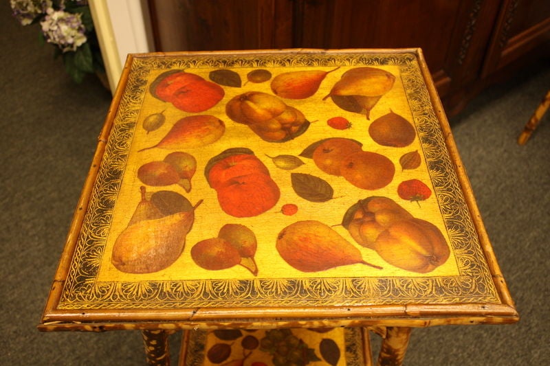 A small antique English side table, decoupaged with Renaissance inspired fruits. The bamboo is in good, sturdy condition. Charming and useful as an end or lamp table.
