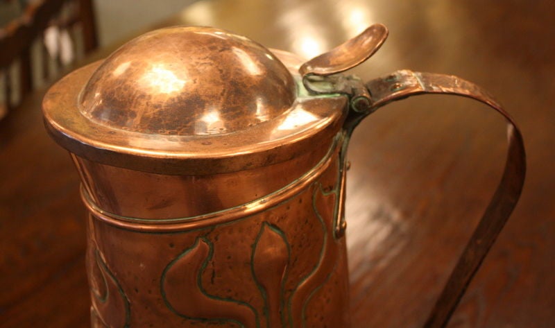 A tall and dramatic English copper jug from the turn of the century. Very imposing. Hand-hammered. Diameter measurement is for the base.
 