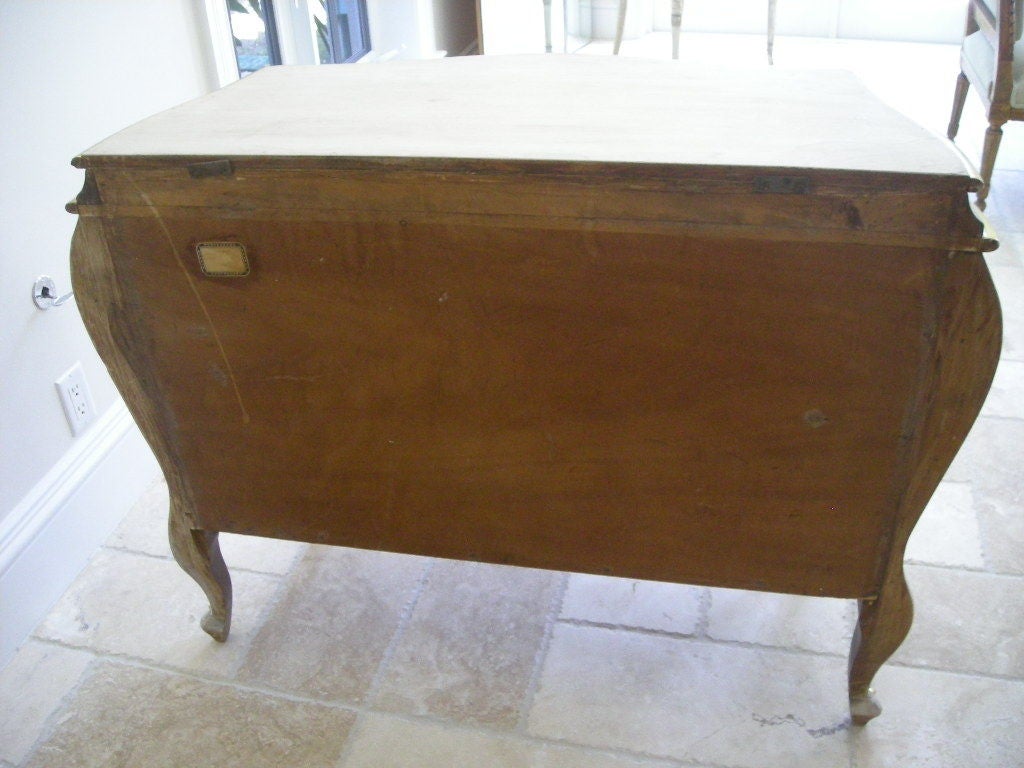 Bleached walnut and water gilded chest of drawers
fitted with bronze hardware.