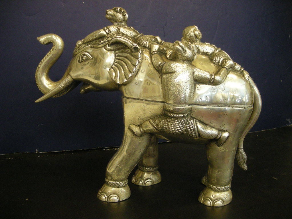 Heavy sterling silver hand-made whimsical elephant box, with a removable top portion that is adorned with frolicking monkeys.