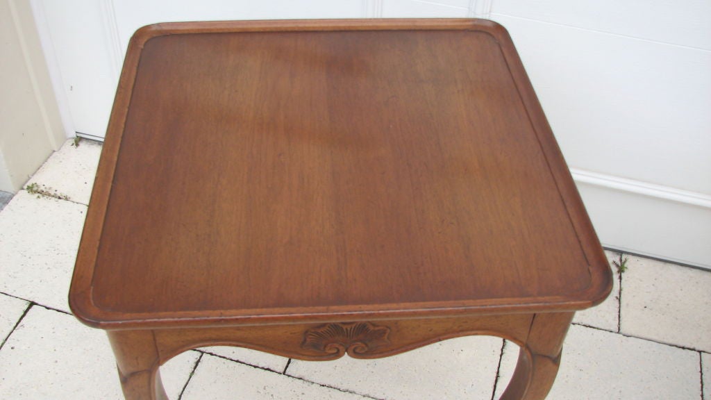 Chestnut wood side tables with hoof feet, fitted with a center drawer and bearing the maker's signature