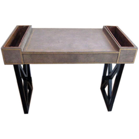 An elegant French Mid-Century Modern Neoclassical desk in the style of Jean-Michel Frank. The piece was hand made by a small French workshop and is original in design, handsome and functional. The writing table has a classic, ebonized wood X-Frame