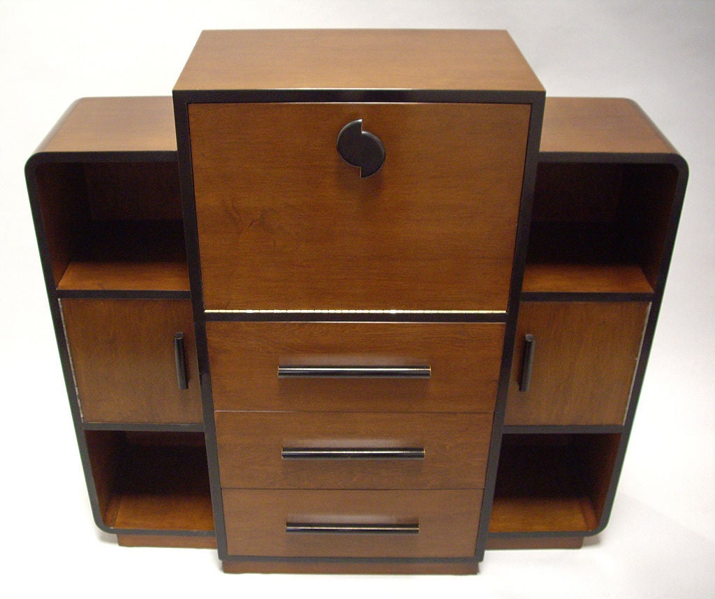 American streamline modern drop front desk featuring three large drawers, bookcases, and storage compartments. The desktop is sturdy and  standard height.<br />
Designed for Modernage Furniture Company of New York.