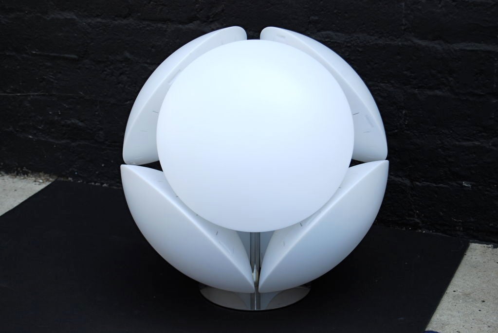 This is a very cool and unusual lamp comprised of 6 white plastic discs attached to a chrome base that illuminate independently.  <br />
<br />
Retains original label