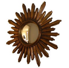 A wooden gold sunburst mirror