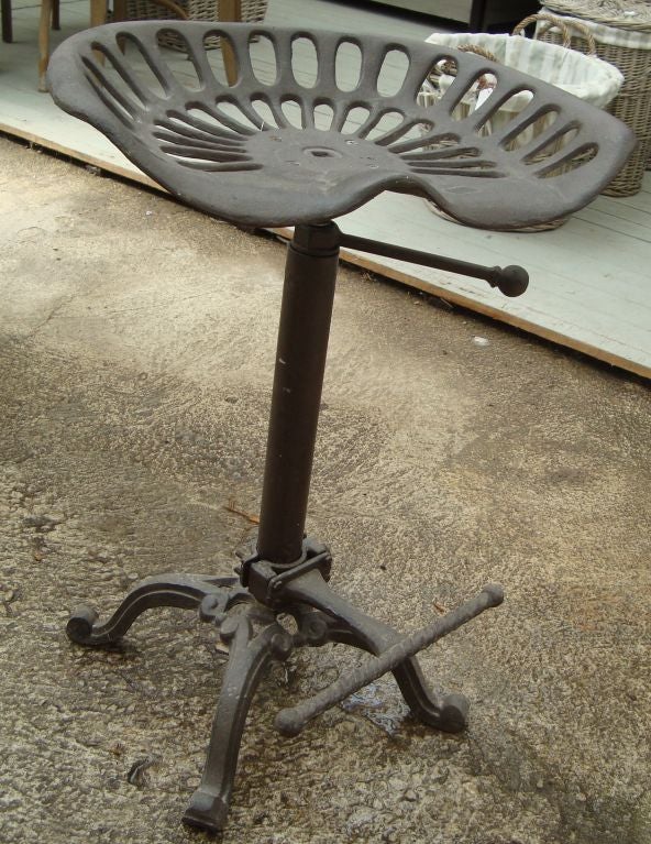 A pair of black cast iron adjustable stool