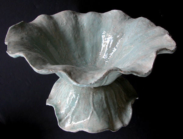A delightful French celadon-enameled iron cabbage-form bowl; the well-delineated deep cabbage leaf bowl with everted undulating rim raised on a similar downturned base.