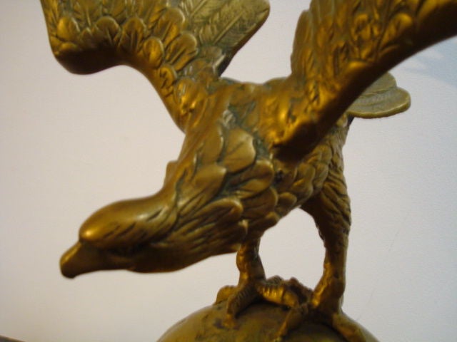 THIS WONDERFUL LARGE EAGLE SITS ON A GLOBE AND ORIGINALY WAS ON A FLAG POST FROM A OLD BANK OR FEDERAL BUILDING. THIS SOLID BRASS EAGLE IS MOUNTED ON A IRON MOUNT AND COMES FROM A PRIVATE COLLECTION IN PENNSYLVANIA.IT HAS GREAT FORM AND PRESENCES. I