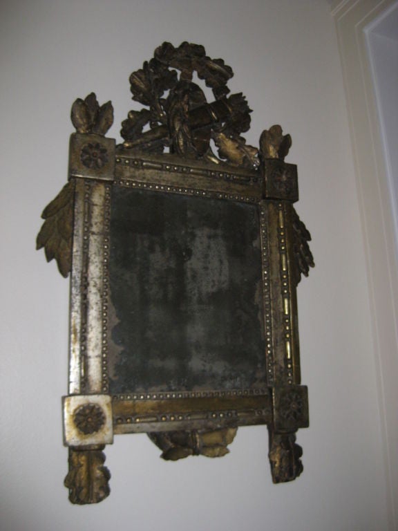Charming silvered mirror with highly carved frame