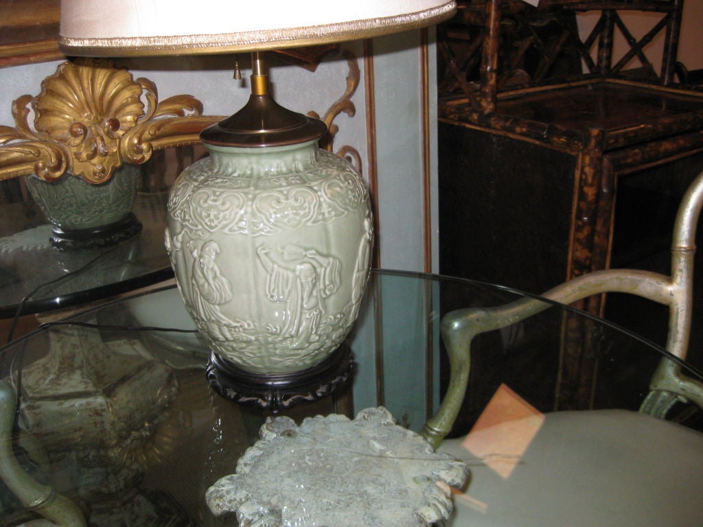 Great looking asian lamp in celedon with carved wood bottom base and carved stone finial