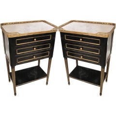 A pair ebonized, marble top side tables in the Jansen manner