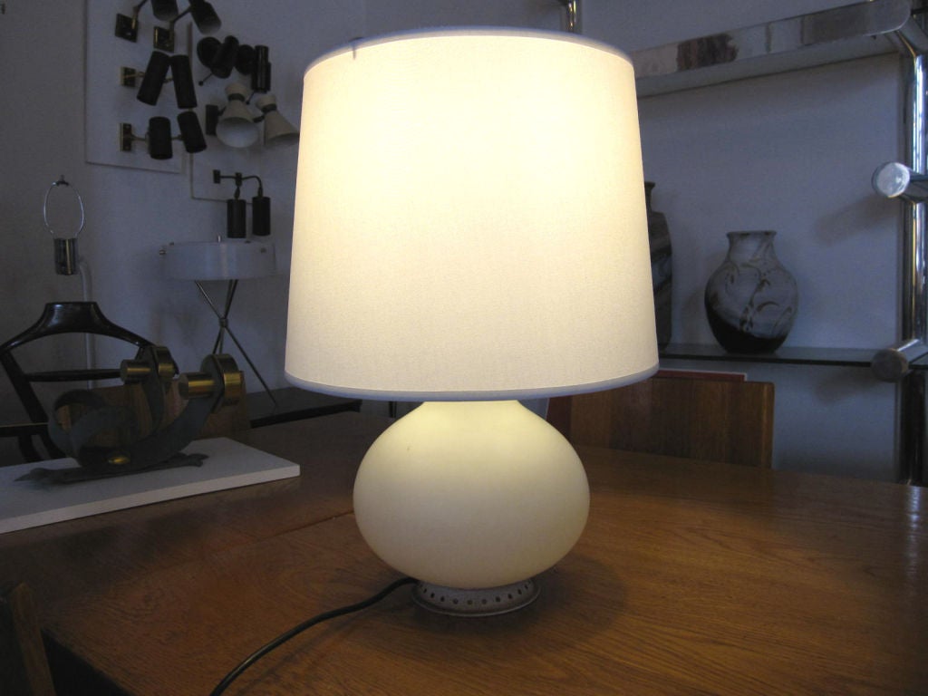 Sweet little Opaline glass lamp with both top and interior bulb source, providing lovely diffused light.  Early example with aged hardware and two button switch. Signed on switch.