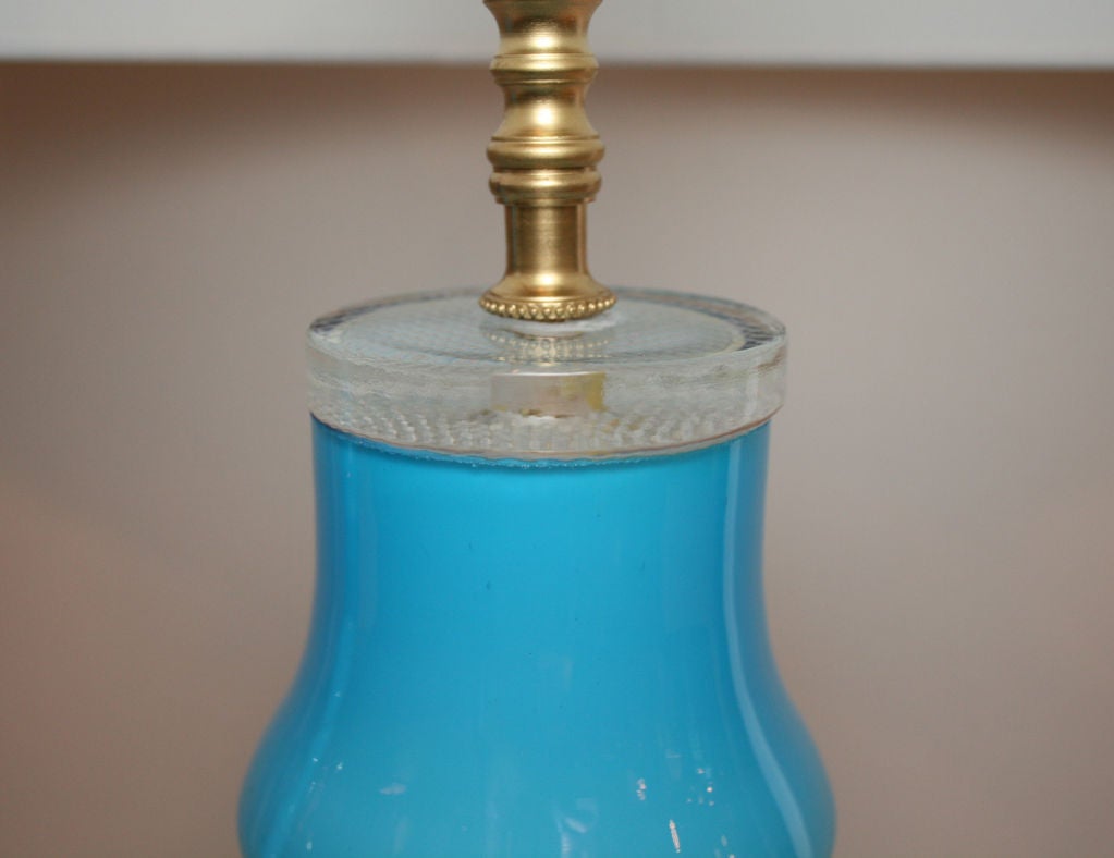 Pair of cerulean blue table lamps by Johanfors, with brass hardware and drum shades. The vibrant blue glass is cased within clear glass. Dimensions with the shade are 23