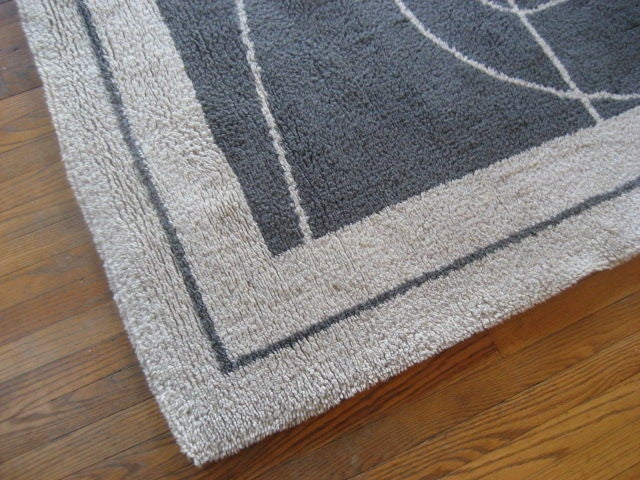 A great modernist rug by P.Cardin in gray with beige border. Signed.