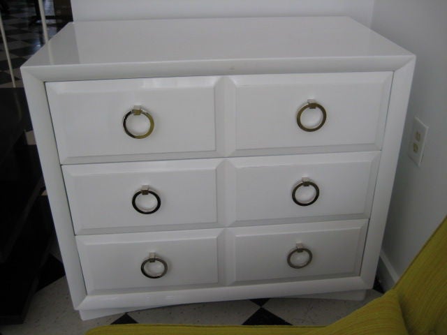A classic chest of drawers by T.H. Robsjohn-Gibbings for Widdicomb, completely redone in white lacquer. Brass handles in satin nickel.