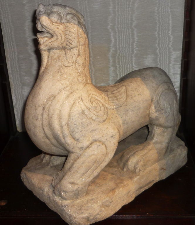 CHINESE CARVED MARBLE FIGURE OF A MYTHICAL 'CHIMERA' (SEE BELOW).MING DYNASTY OR POSSIBLY EARLIER.<br />
<br />
The term chimera describes a fantastical creature with the head of a dragon, horns of a ram, body of a lion and wings of a bird. Such