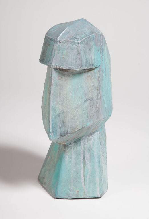 A bust with attenuated abstract features – a deep brow, an elongated angular face, and a chiseled chin – produced in tin but its patinated appearance reads a heavy, weathered bronze. Italian, circa 1970.