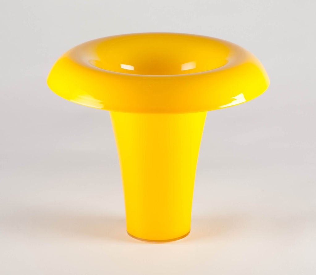 A vortex shaped flower vase with a conical form that has a deep fold to its edge, in a glamorous marigold yellow. By Salviati, Italian, 1998.