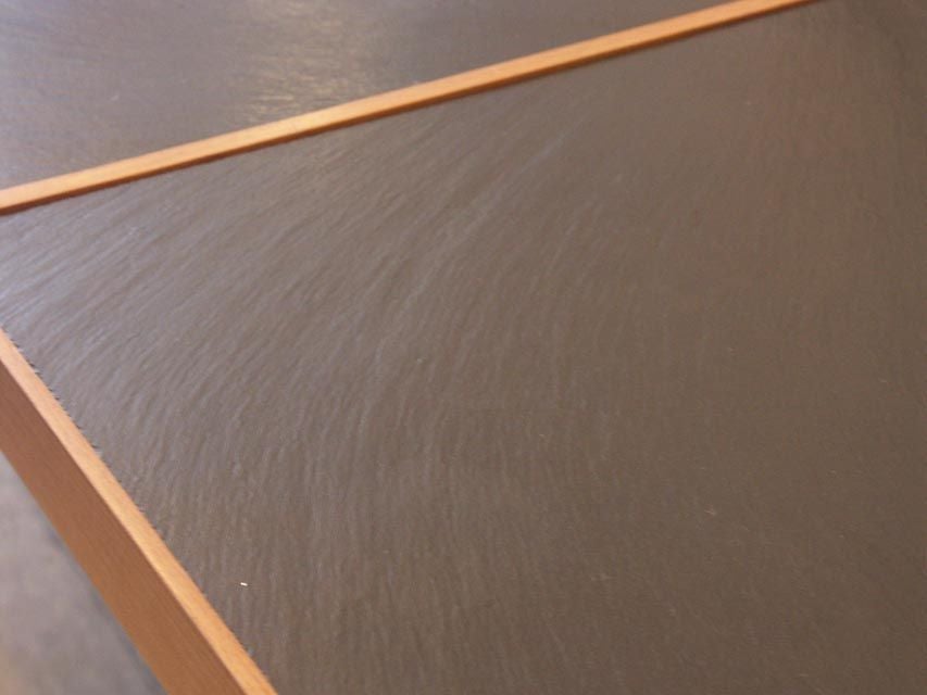 Very nice reductionist design, manufactured by Cassina. A delicate maple frame, with box join corners, features a pair of inset black slate tops. The tabletop is raised on 4 painted steel 