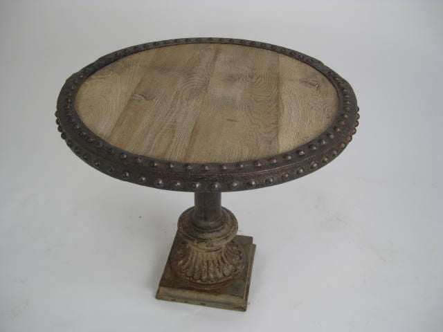 round table with riveted top and iron base