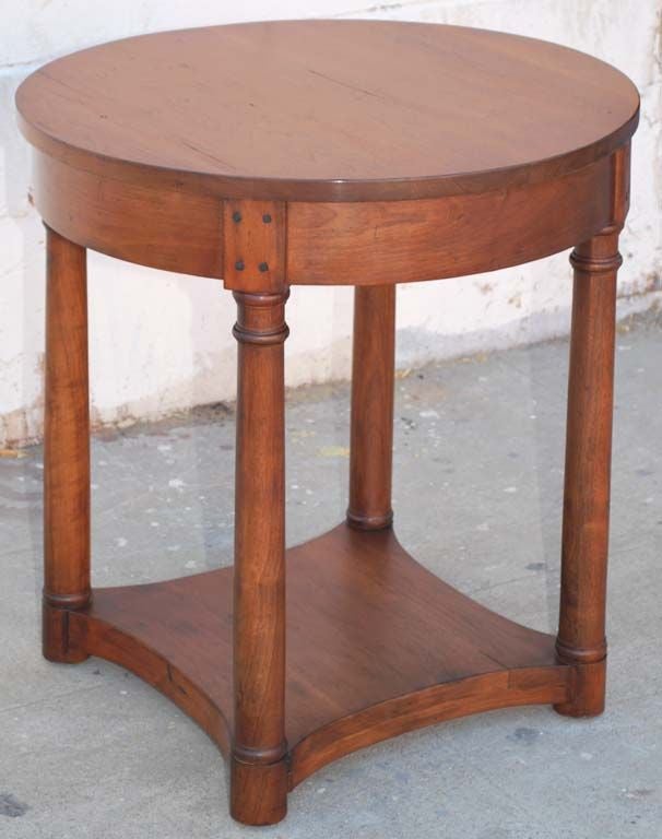 This round side table with turned legs and shelf is made of distressed walnut. It is seen here in a 28