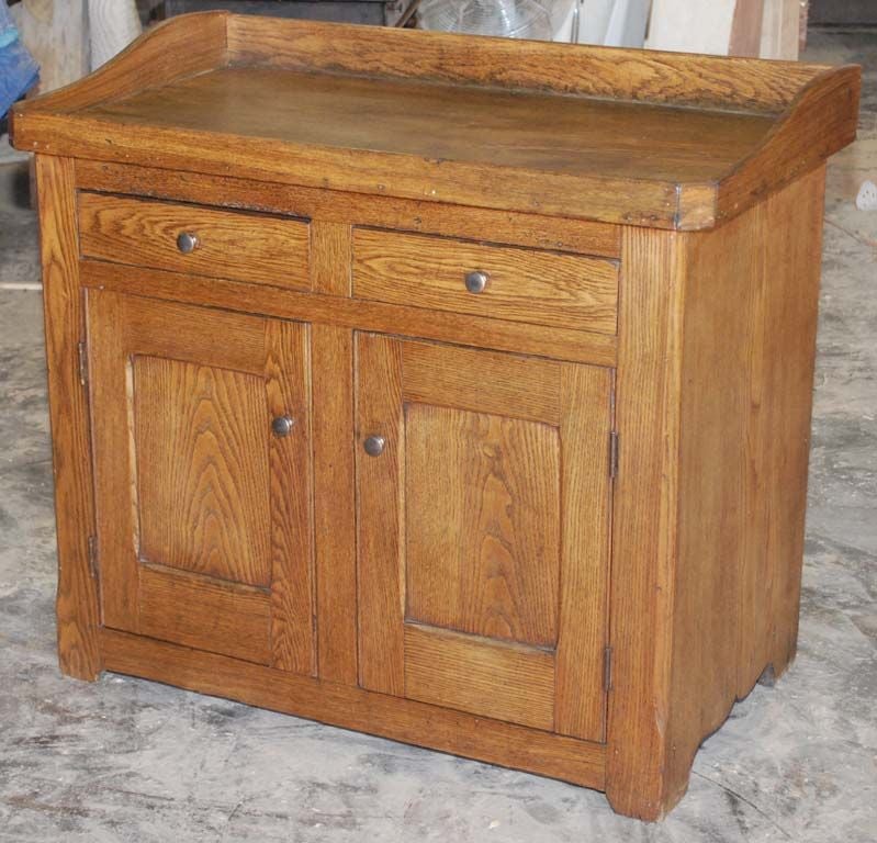 Well built vanity from the turn of the last century. Ideal to hold a sink in a guest bath or powder room. Originally intended to be used with basin and water pitcher, it has a lip and back splash all around.