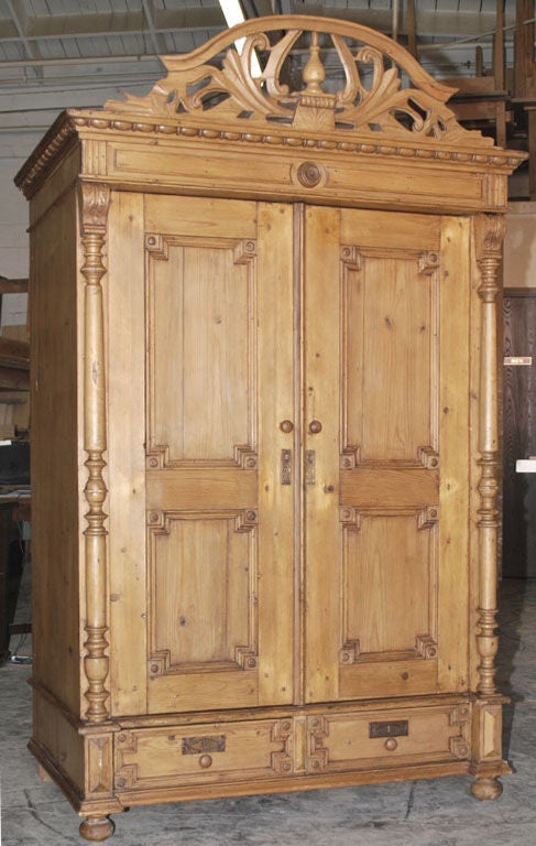 Beautiful 19th century armoire with extensive carvings, turnings and decorative moldings. Has two drawers below. This piece is extremely well-made, all corners joined by dove-tail joints. Doors and walls are over 1