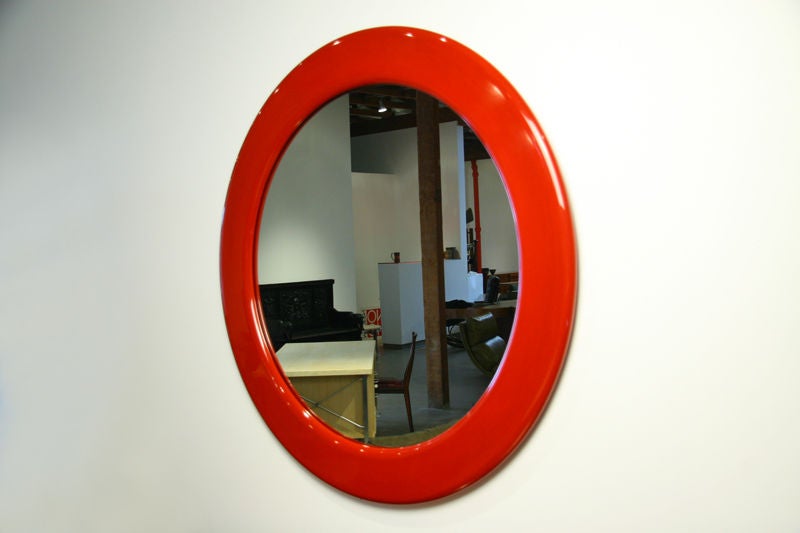 A large Milo Baughman round red lacquered mirror