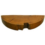 A solid peroba half round wall mounted shelf