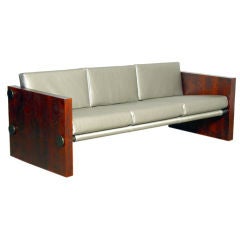 Case sofa with red oak sides and bronze finished metal elements