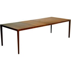 A walnut parsons table with two leaves by John Kapel for Glenn