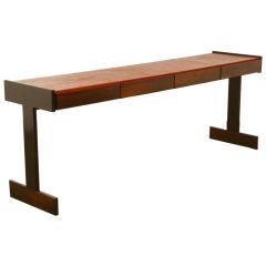 A four drawer console table in Rosewood and red leather