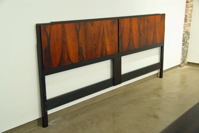A rosewood wood panel headboard with ebonized oak frame.
