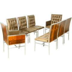 A set of 8 rosewood chrome and tufted leather dining chairs