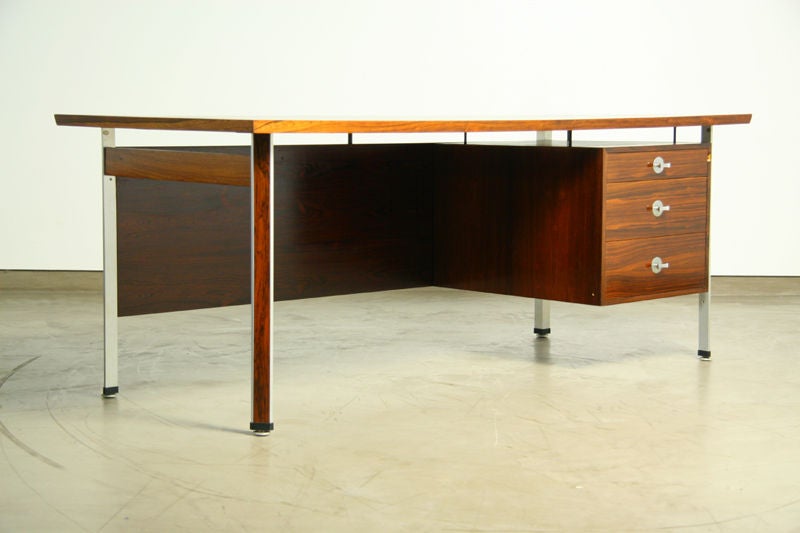 A rosewood desk with aluminum strips and pulls designed by Finn Juhl.