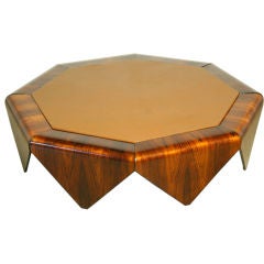 A octagonal rosewood coffee table with inset leather top