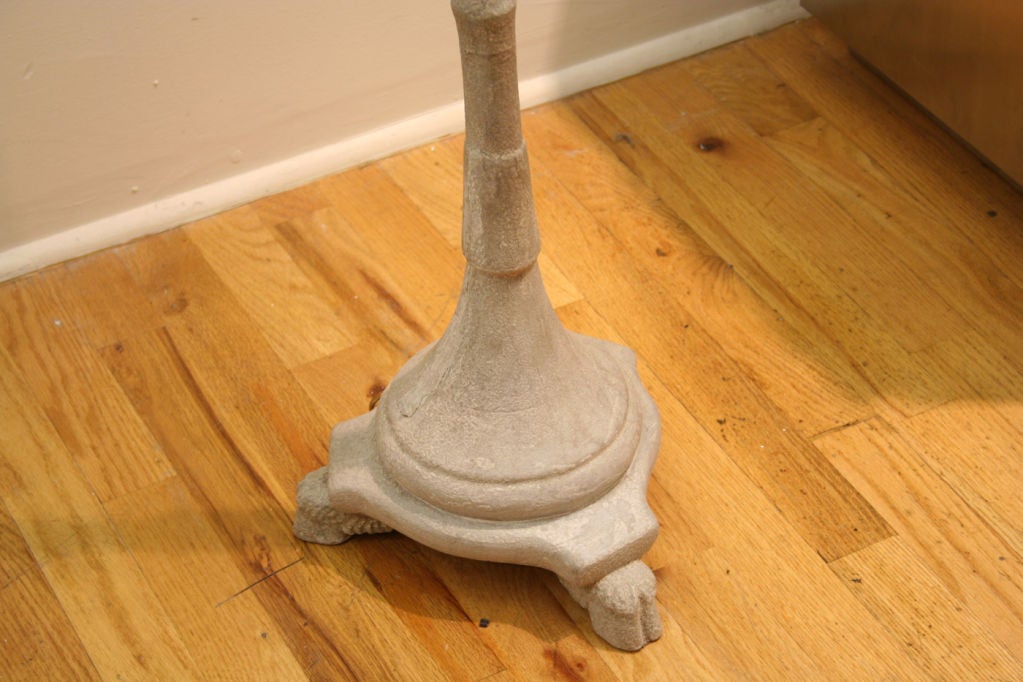 Floor lamp, the top cast as a ram's head above narrow support ending in a circular base, on three feet cast as cloven hooves, with brass fittings for two bulbs