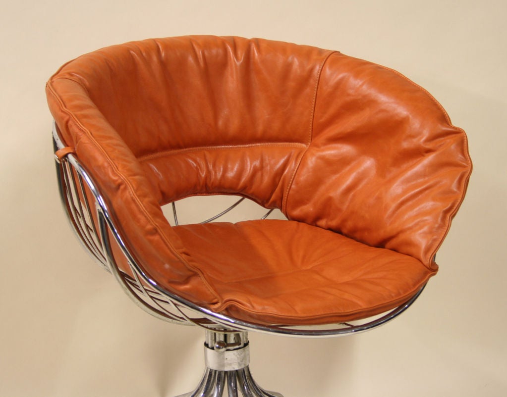 PAIR OF FRENCH SWIVEL CHAIRS IN POLISHED STEEL WITH ORANGE LEATHER CUSHIONS