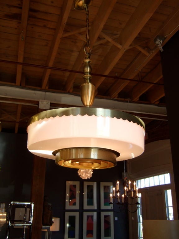 Classic shape brings elegance to our large midcentury chandelier. Perforated and scallop details on the brushed brass.