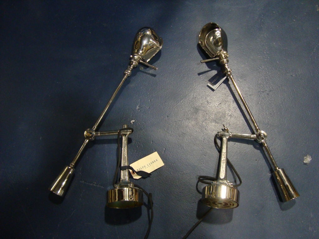 A pair of Ralph Lauren Polished nickel classic Boom Arm wall lights ideal for flanking a bed for reading.