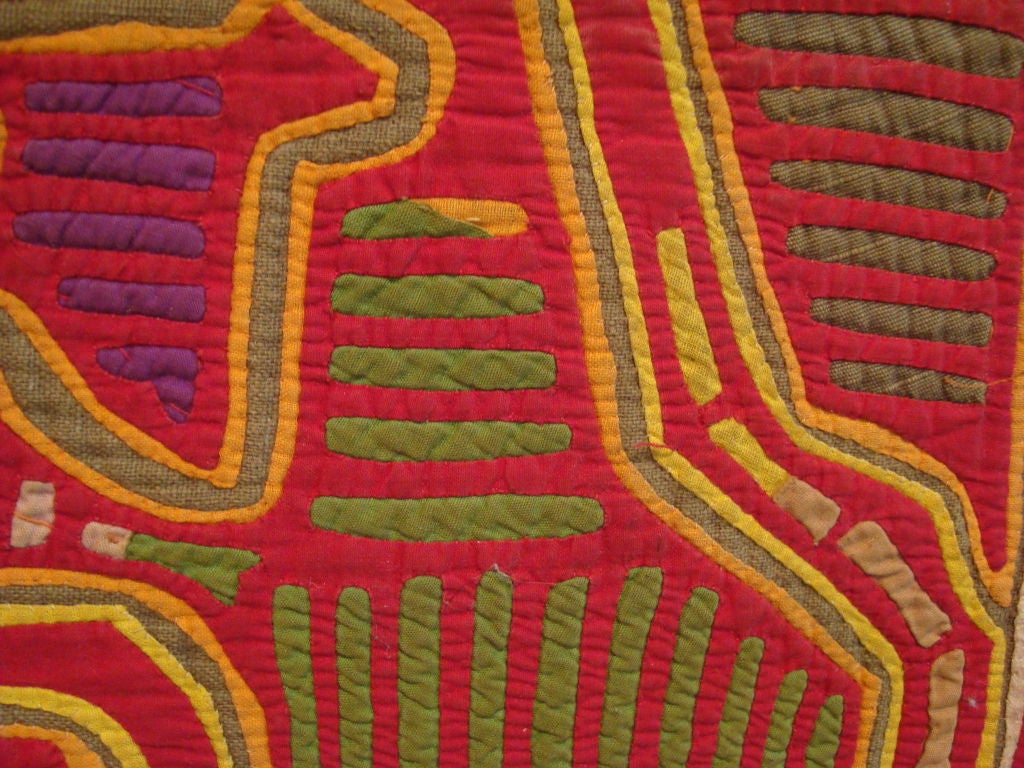 The mola forms part of the traditional costume of a Kuna woman, with two mola panels incorporated as front and back sections of a blouse. In the Kuna people's native language, 
