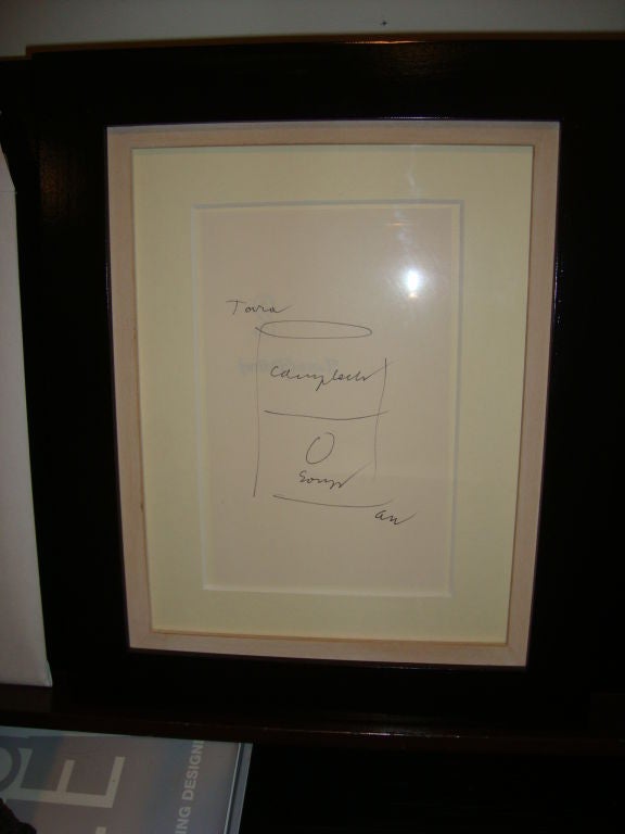 A hand drawing on a page of a book of a Campbell Soup can, an iconic image in Warhol's work, and inscribed to TARA and signed AW. Andy Warhol would draw and dedicate books at signings to friends, and this is one such page. 

Professionally Framed.
