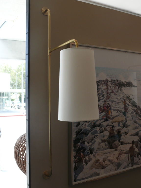 Pair of small scale pole sconce plated in brass with cantilevered arm holding new silk shade. Simple and classic design perfect for any room. Priced individually and available in multiple finishes.<br />
<br />
Shade arm length 15.5 inches<br